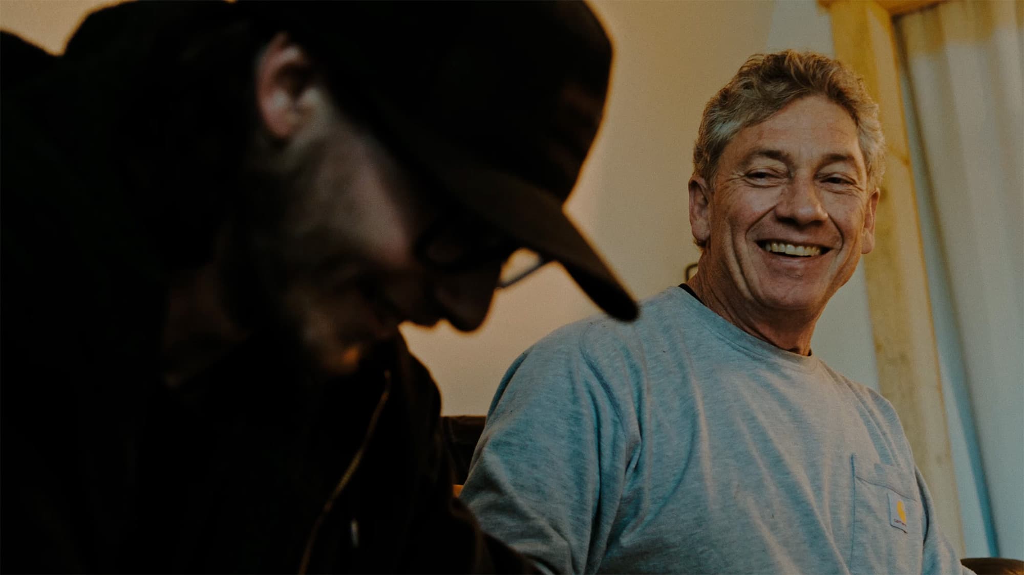 A smiling customer, with a cowboy silhouette in the foreground